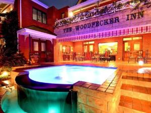a large swimming pool in front of a building at The Woodpecker Inn in Pretoria
