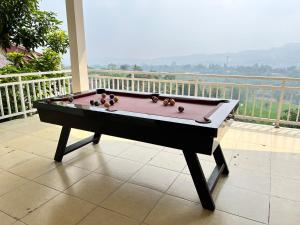 a pool table sitting on top of a balcony at Villa Kay Height in Kopo 2