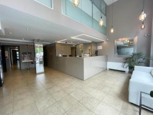 an office lobby with a reception desk and a couch at SM Hotel Teatre Auditori in Barcelona