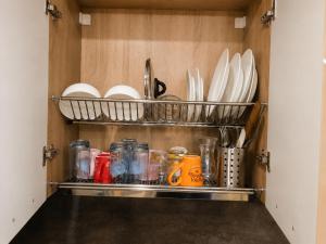 a cupboard filled with plates and utensils at Apartment RELAX, City Centre, Free Wi-Fi, Self Check-In in Ruse +43 photos