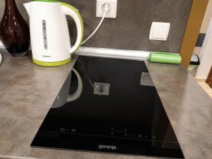 a counter top with a coffee maker and a cup at Apartment RELAX, City Centre, Free Wi-Fi, Self Check-In in Ruse