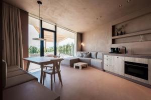 a living room with a table and a couch at Hotel Weingut Stroblhof in Appiano sulla Strada del Vino