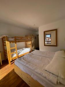 a bedroom with two bunk beds and a mirror at Oberthaler Hotel in Sappada +42 photos