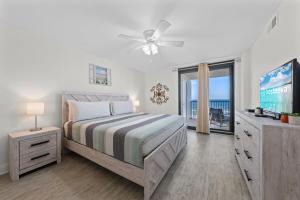 a bedroom with a bed and a flat screen tv at Wind Drift South East 404 in Orange Beach