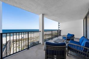 a balcony with chairs and a view of the ocean at Wind Drift South East 404 in Orange Beach