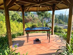 a pool table on a patio under a wooden roof at Villa Kay Serenity in Sampal 2