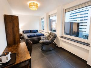 a living room with a couch and a table at Hotelikum zentreal Bequem in Heilbronn