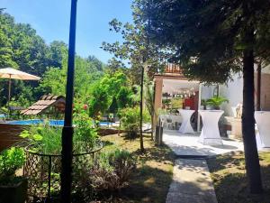 a garden with a pool and a house at Forest Oasis Slatina in Slatina Varoš