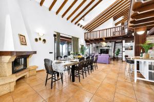 a dining room with a table and chairs and a fireplace at LAS MORADITAS, CHALET con PISCINA PRIVADA in Adeje