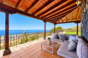 a patio with a couch and a view of the ocean at LAS MORADITAS, CHALET con PISCINA PRIVADA in Adeje