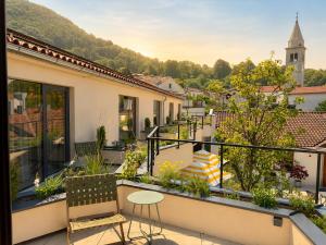 a balcony with a view of a city at Josefina unique hotel, adult only in Kozina