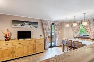 a living room with a television and a dining room at Punta Ceresole 4061 Maison Gerard in Cogne