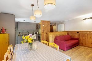 a kitchen and dining room with a table and a red couch at Punta Ceresole 4061 Maison Gerard in Cogne +27 photos