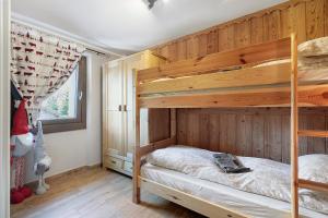a bedroom with a bunk bed and wooden walls at Punta Ceresole 4061 Maison Gerard in Cogne