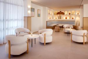 a waiting room with white chairs and tables at Alua Linda Mallorca - Newly Renovated 2026 in Can Pastilla
