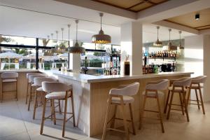 a bar with a row of stools in a restaurant at Alua Linda Mallorca - Newly Renovated 2026 in Can Pastilla +24 photos