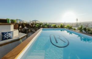 a swimming pool on the roof of a building at Royale Sainte Hélène Boutique Hotel in Birkirkara