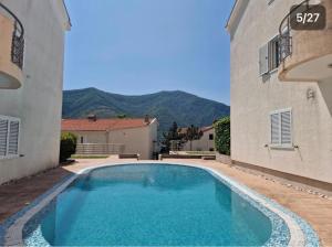 a swimming pool in the courtyard of a building at Victor Kotor Sea view in Dobrota