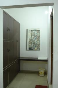 a room with a shelf and a painting on the wall at Mansarover Hotel & Banquets in Bareilly +62 photos