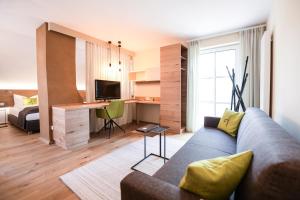 a living room with a couch and a desk at Genussgut Krispel in Neusetz