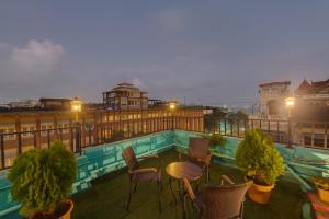 a patio with chairs and a table on a balcony at Hotel Suba Palace Near Gateway of India in Mumbai