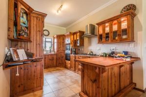 a large kitchen with wooden cabinets and a counter top at New Wave Accommodation in George