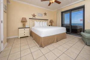 a bedroom with a bed and a large window at Phoenix VI 61408 in Orange Beach