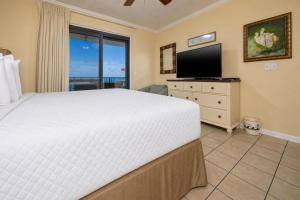 a bedroom with a large bed and a television at Phoenix VI 61408 in Orange Beach +57 photos
