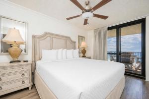 a bedroom with a white bed and a balcony at Phoenix VI 6906 in Orange Beach +62 photos