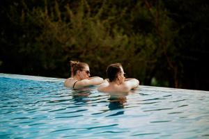 a man and a woman in a swimming pool at Pembeni Rhotia in Karatu