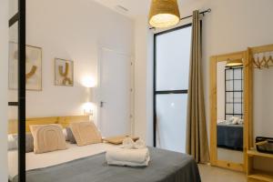 a bedroom with a bed and a large window at Niña Mala in Valencia