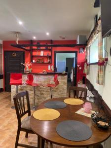 a dining room with a table and chairs and red walls at Texaco in Kazimierz Dolny