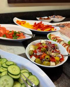 a table filled with plates of food with vegetables at Hotel Angerbräu in Murnau am Staffelsee