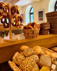 a shelf filled with lots of different types of bread at Hotel Angerbräu in Murnau am Staffelsee