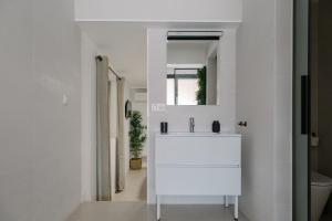 a white bathroom with a sink and a mirror at Niña Mala in Valencia +62 photos