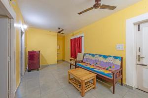 a room with a couch and a table in it at Prince Park in Pondicherry