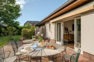 a patio with two tables and chairs with fruit on it at Seemannshus in Born