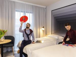 a man holding a frisbee in a hotel room at ibis Timisoara City Center in Timişoara