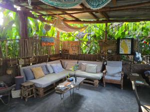 a living room with a couch and a table at Backyard Eco Bungalows Moshi in Moshi