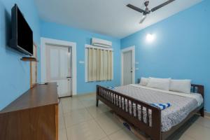 a bedroom with a bed and a flat screen tv at Prince Park in Pondicherry