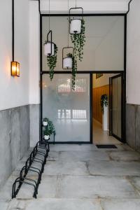 a row of benches in a hallway with plants at Niña Mala in Valencia