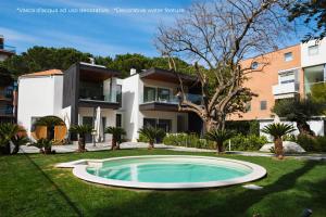 a swimming pool in a yard in front of a house at Luxury B&B La Riserva Dannunziana in Pescara