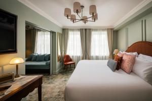 a hotel room with a bed and a couch at Castle Hotel Windsor in Windsor +52 photos