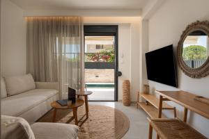a living room with a couch and a table at Villas THALLO in Paradisos