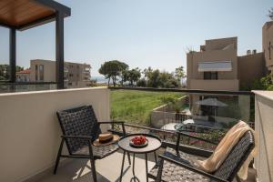a balcony with two chairs and a table at Villas THALLO in Paradisos