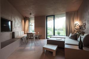 a living room with a couch and a table at Hotel Weingut Stroblhof in Appiano sulla Strada del Vino