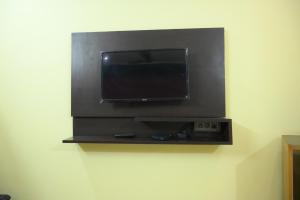 a flat screen tv hanging on a wall at Mansarover Hotel & Banquets in Bareilly