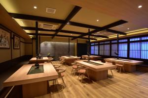 a large room with tables and chairs and windows at Hotel Kazurabashi in Miyoshi +90 photos