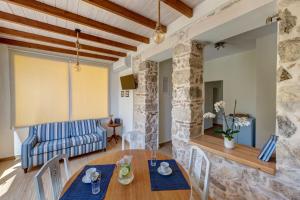 a dining room and living room with a table and chairs at Garden Residence in Ermoupoli