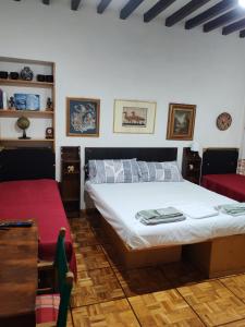 a bedroom with a large bed and a red chair at Casa Chicco Parma in Parma